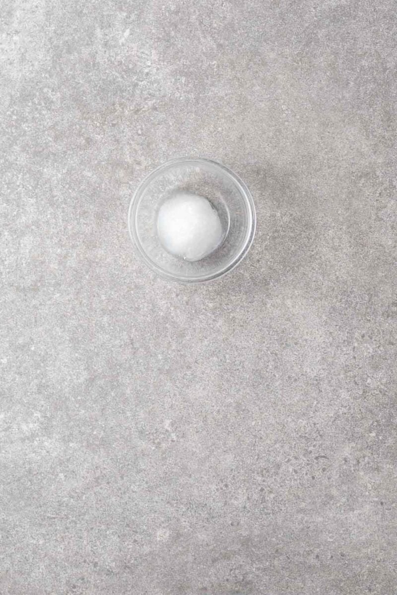 A small glass bowl with coconut oil.